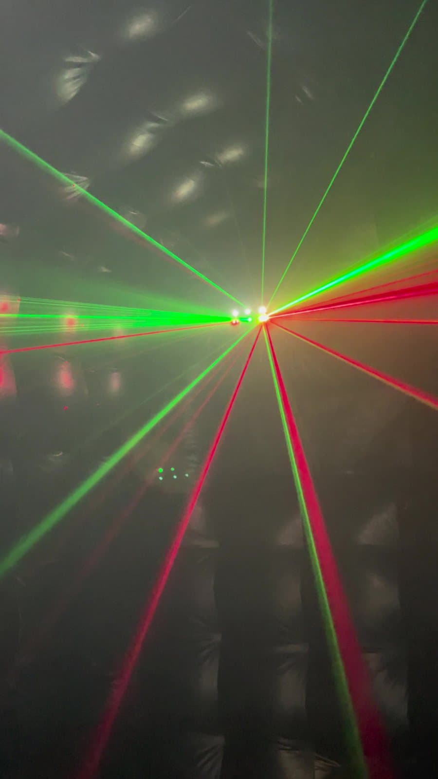 A green laser fan across the room inside the club