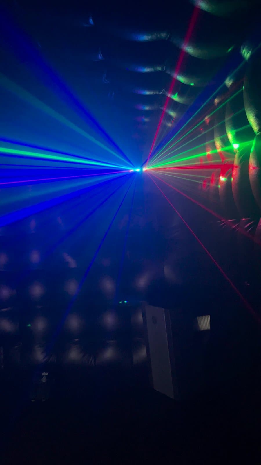 Blue and green lasers fanning across the tufted walls inside the club