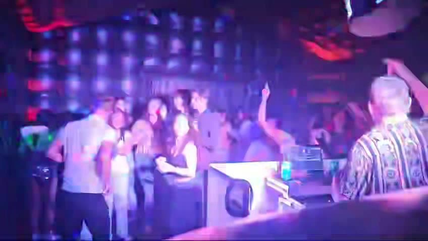 A packed dance floor inside a Yard Clubs nightclub, the DJ at his booth in front