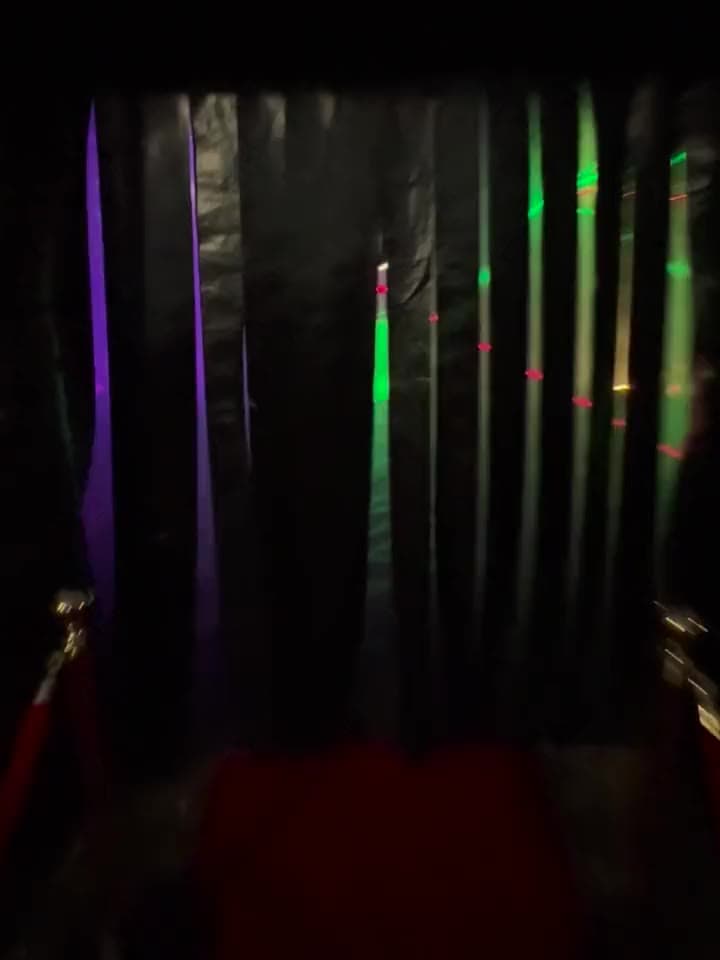 The black strip curtain at the door of a Yard Clubs nightclub, lit from inside