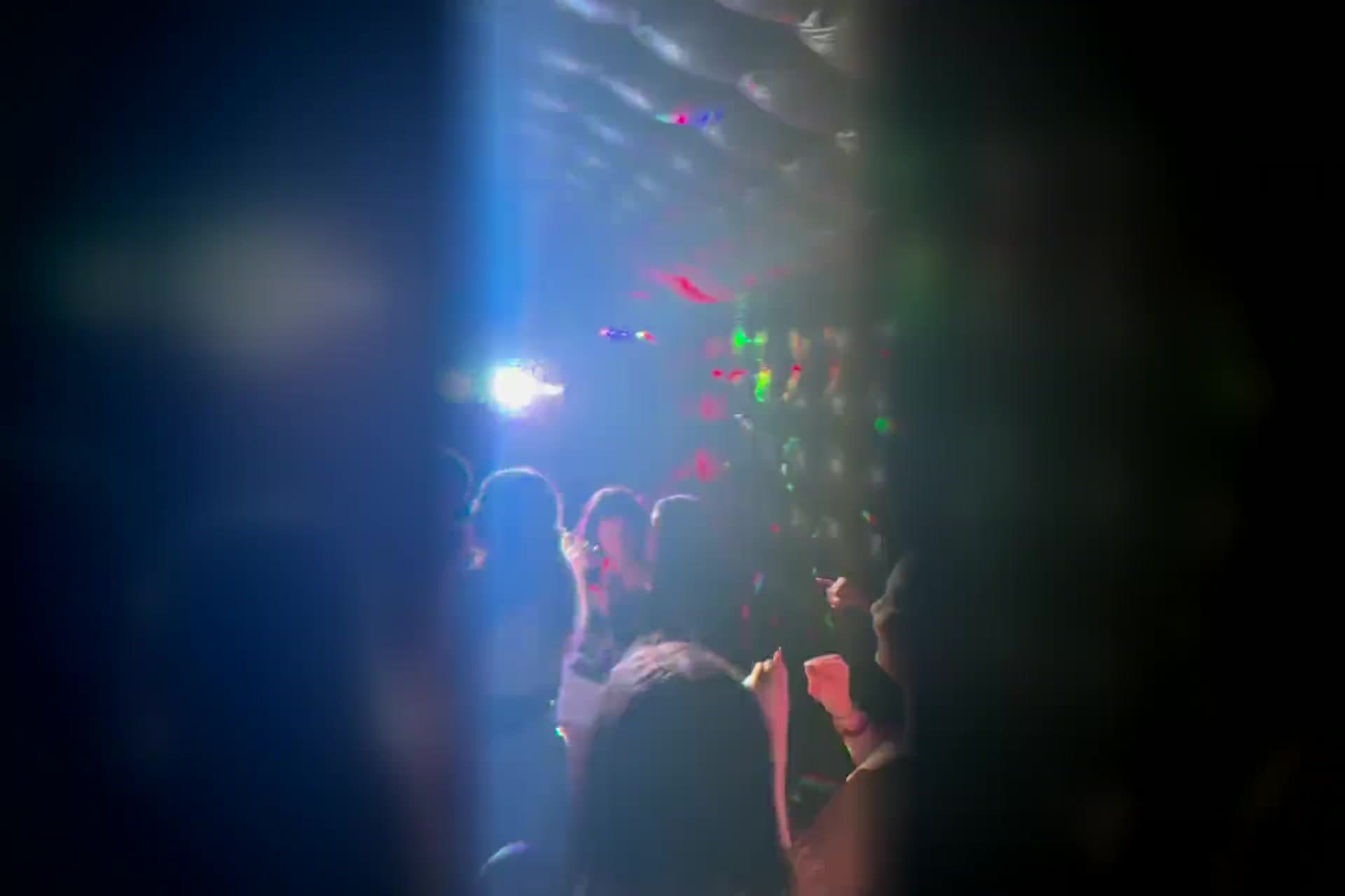 Inside a Yard Clubs nightclub during a party: guests dancing under colored club lights